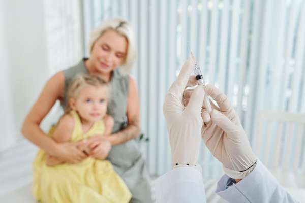 A mother and her anxious child waiting to receive a needle injection